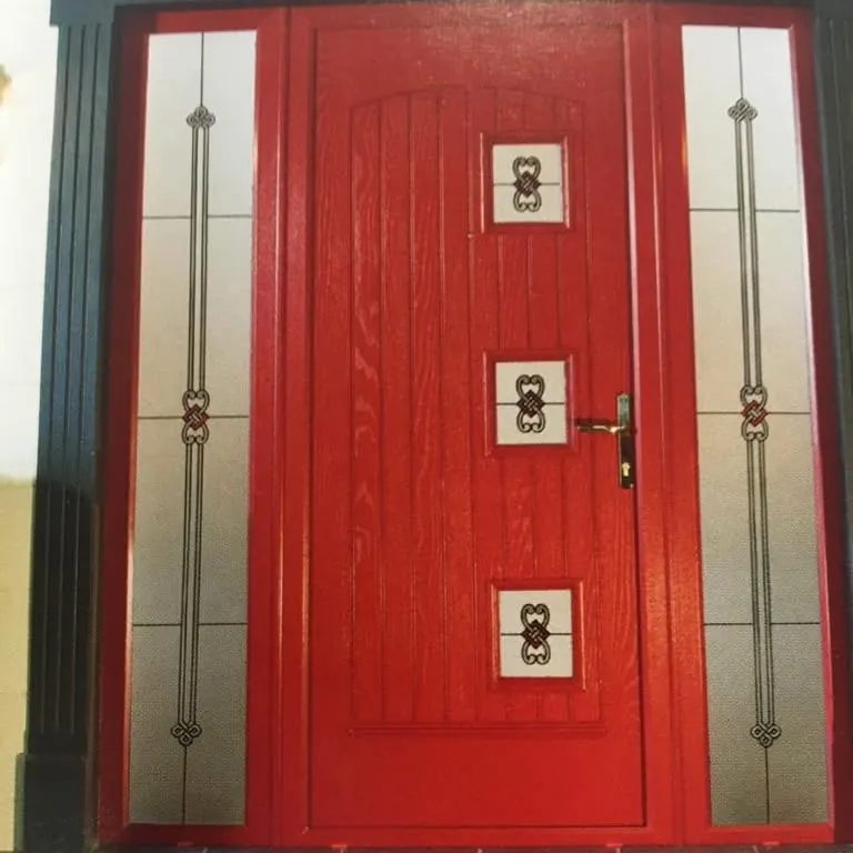 Red front door with decorative glass inserts and side lights